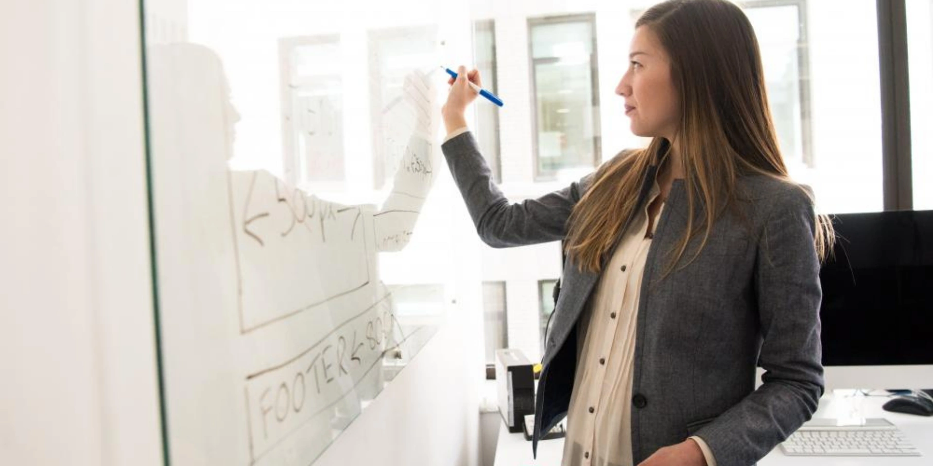 A female student writing on a whiteboard