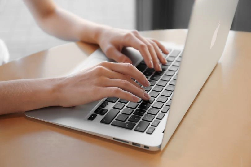 person typing on a laptop