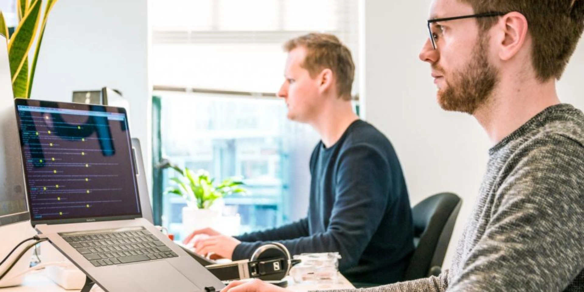 Two peoples working in front of their laptop